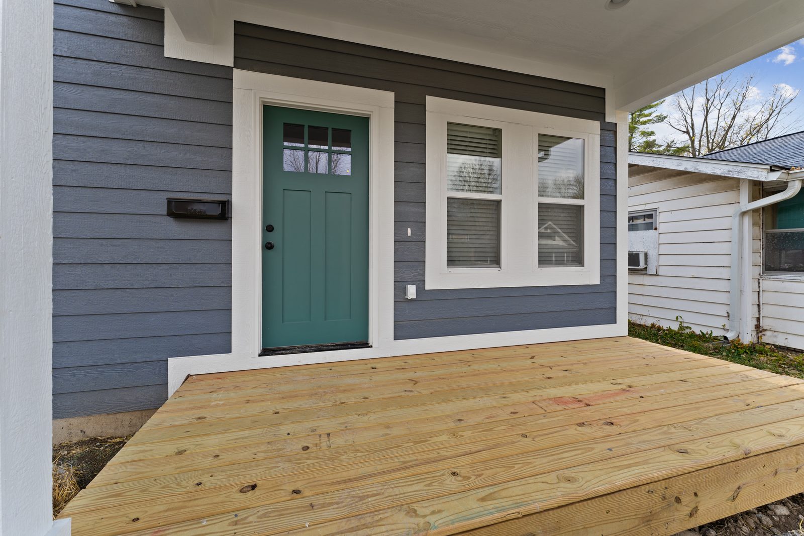 Teal front door and new porch deck
