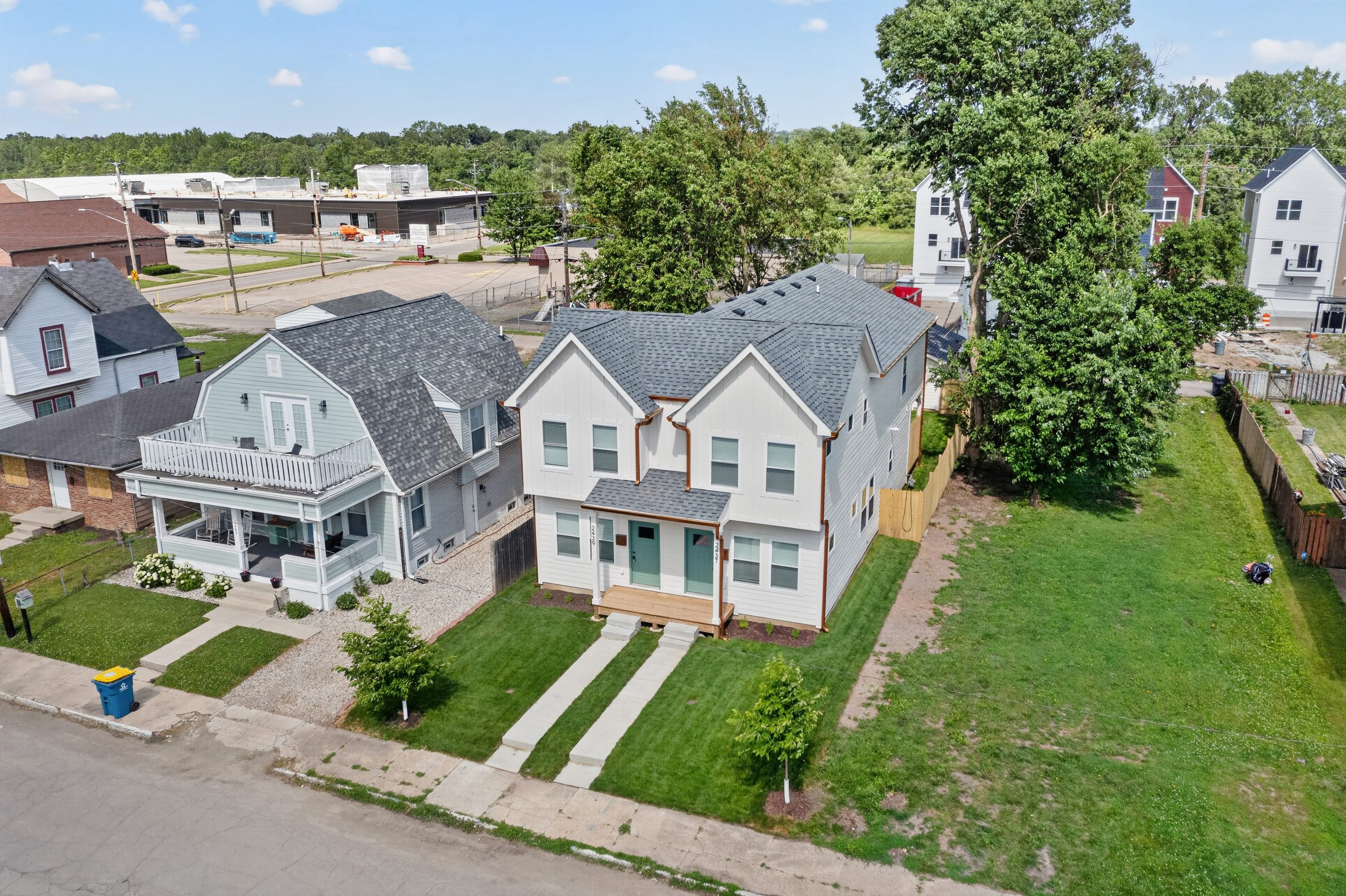 Aerial three-quarter view of the duplex on its block