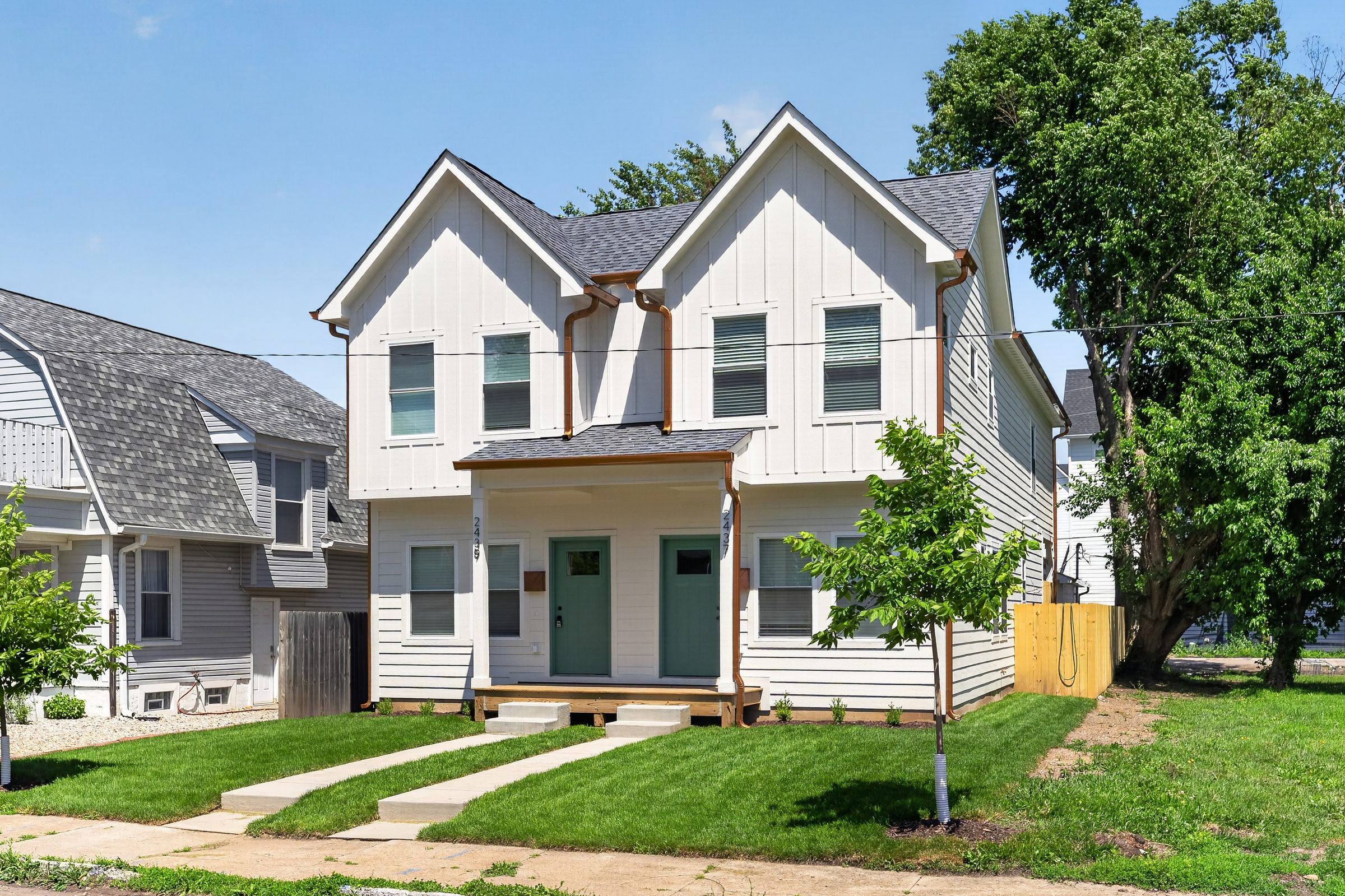 Duplex front at an angle with young street trees