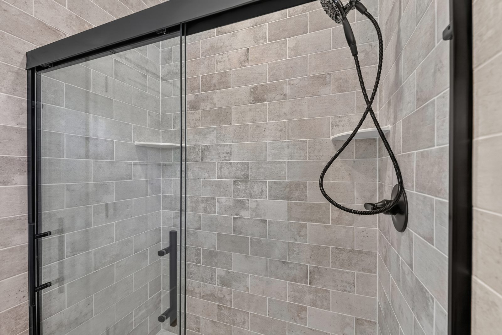 Tiled shower with black fixtures