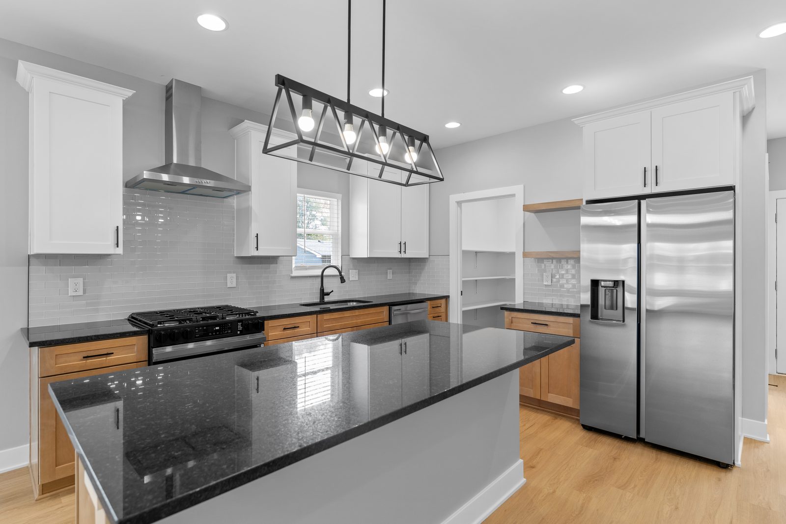 Two-tone kitchen with black granite island