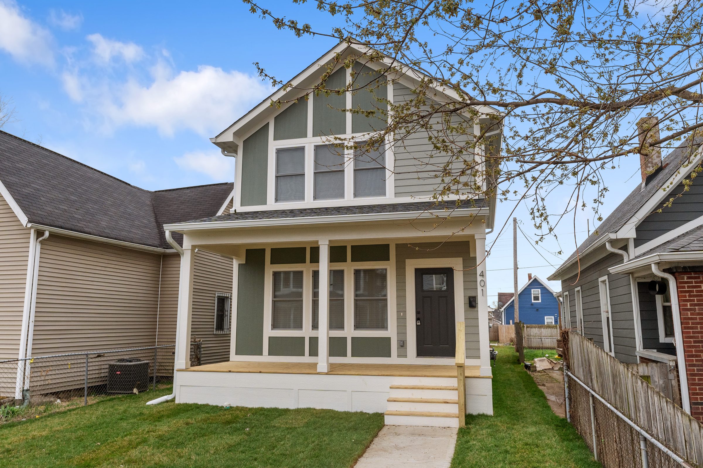 Sage-green craftsman with a deep front porch
