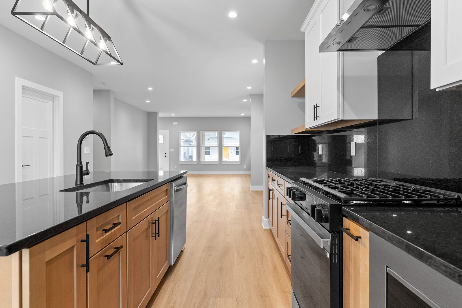 Gas range and black tile backsplash
