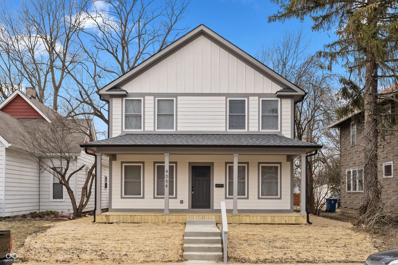Light gray two-story with a full-width porch