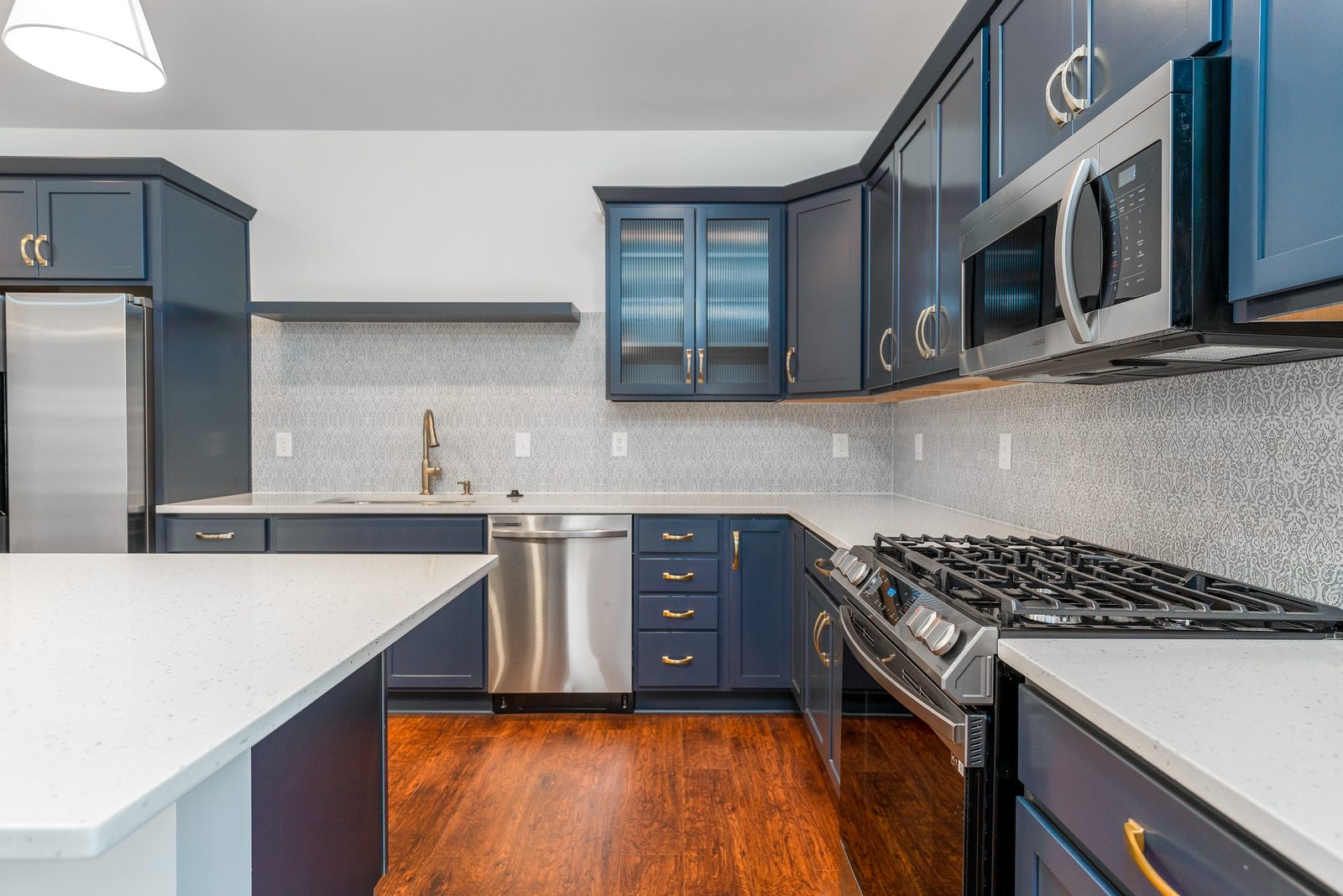 Kitchen with gas range and glass-front cabinets
