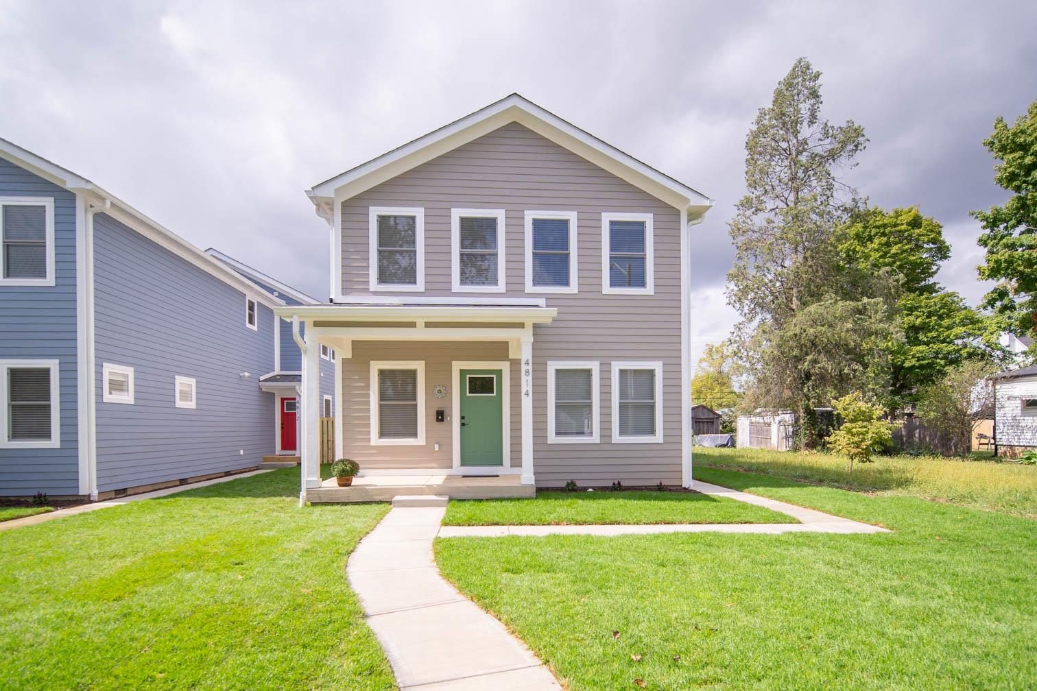 Greige home with a green door
