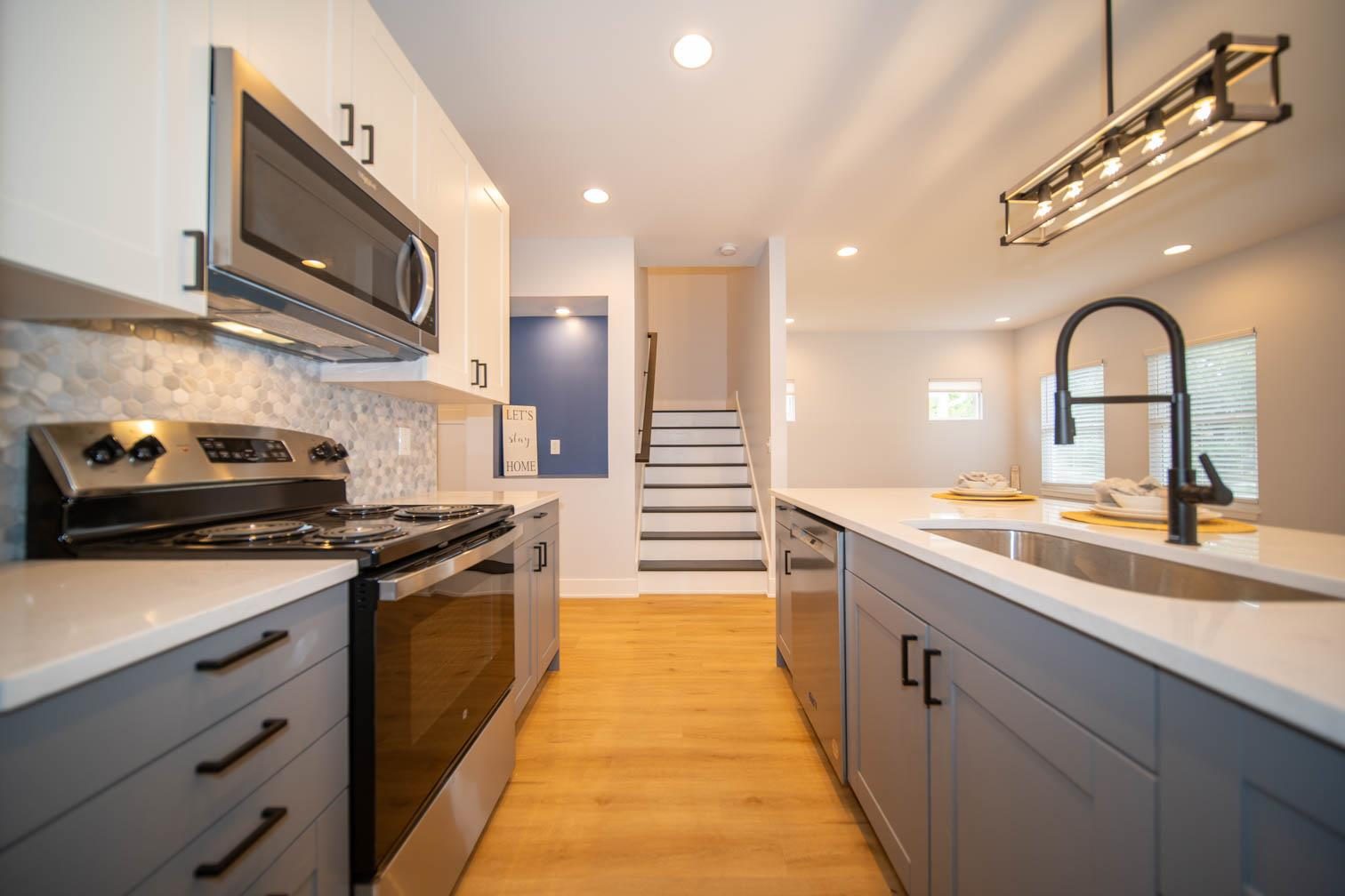 Kitchen with gray cabinets and hex tile backsplash