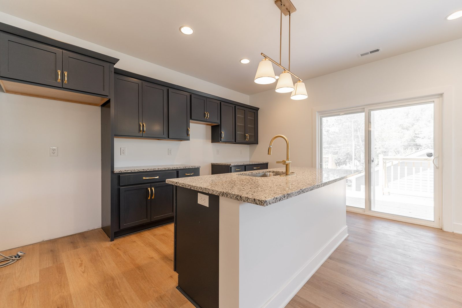 Kitchen with black cabinets and sliding door